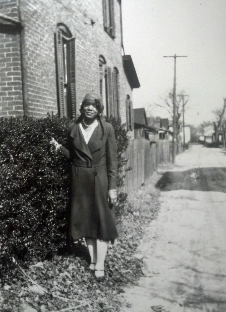 Unknown woman next to Dr. M.T. Pope House, ca. 1920. Image courtesy of City of Raleigh Historic Resources and Museums Program — Dr. M.T. Pope House Museum